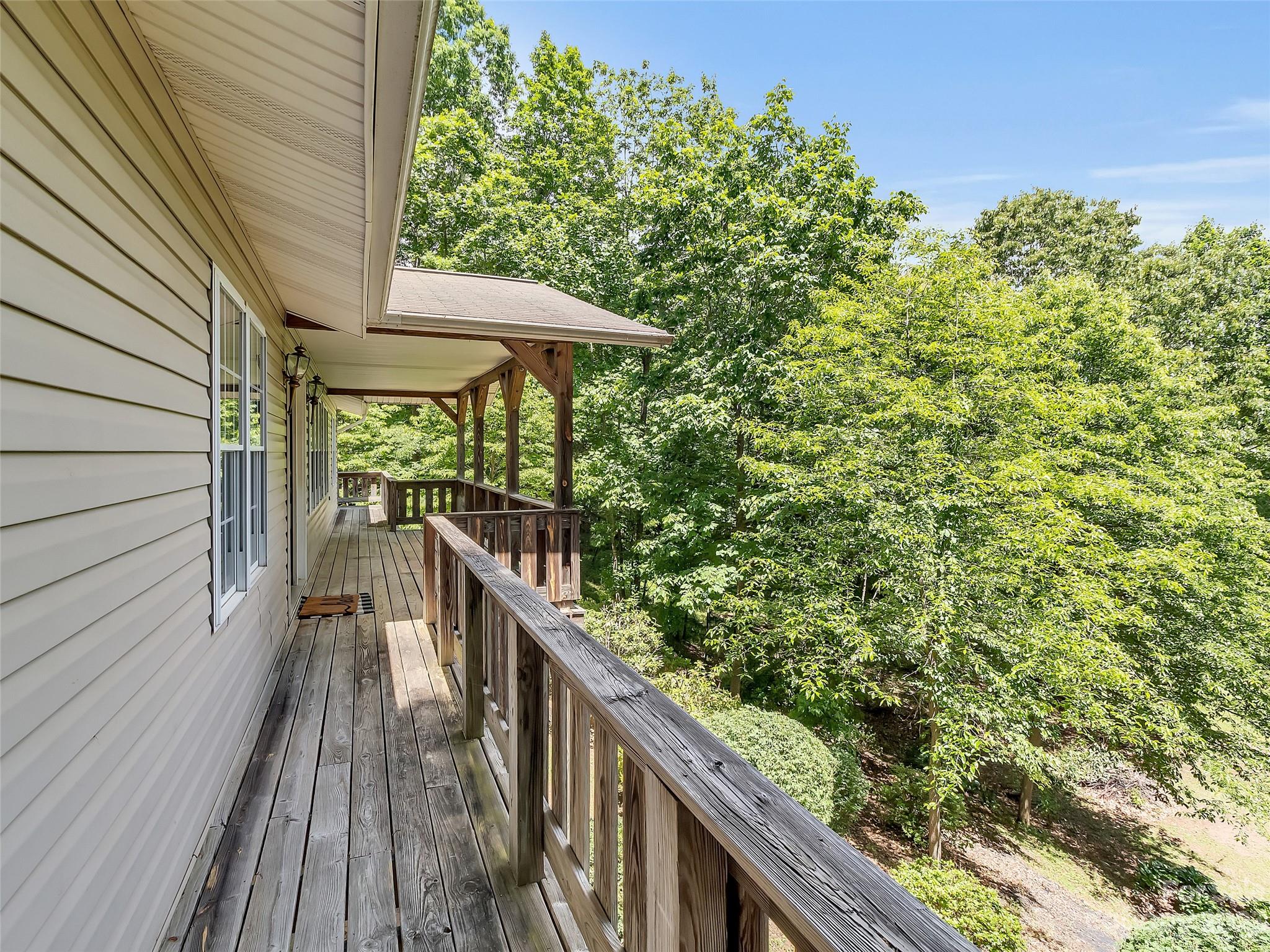 799 Nellie John Drive Clyde, NC 28721 - Photo 13 of 38 a balcony with wooden floor and outdoor space