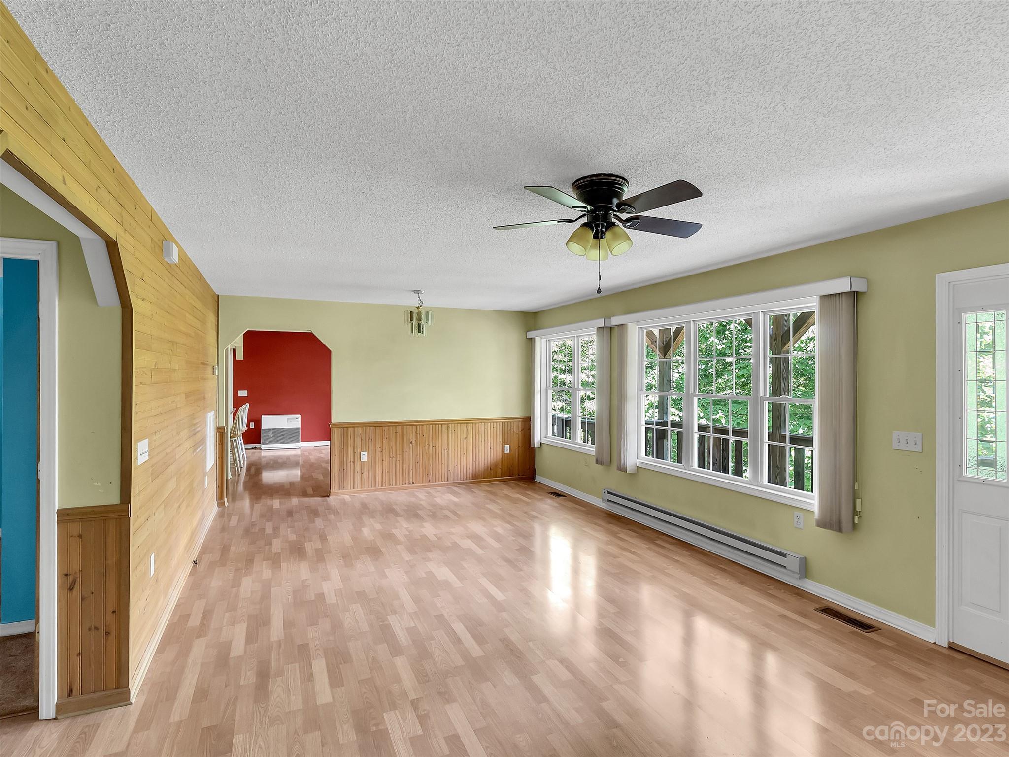 799 Nellie John Drive Clyde, NC 28721 - Photo 19 of 38 a view of livingroom with furniture window and a ceiling fan