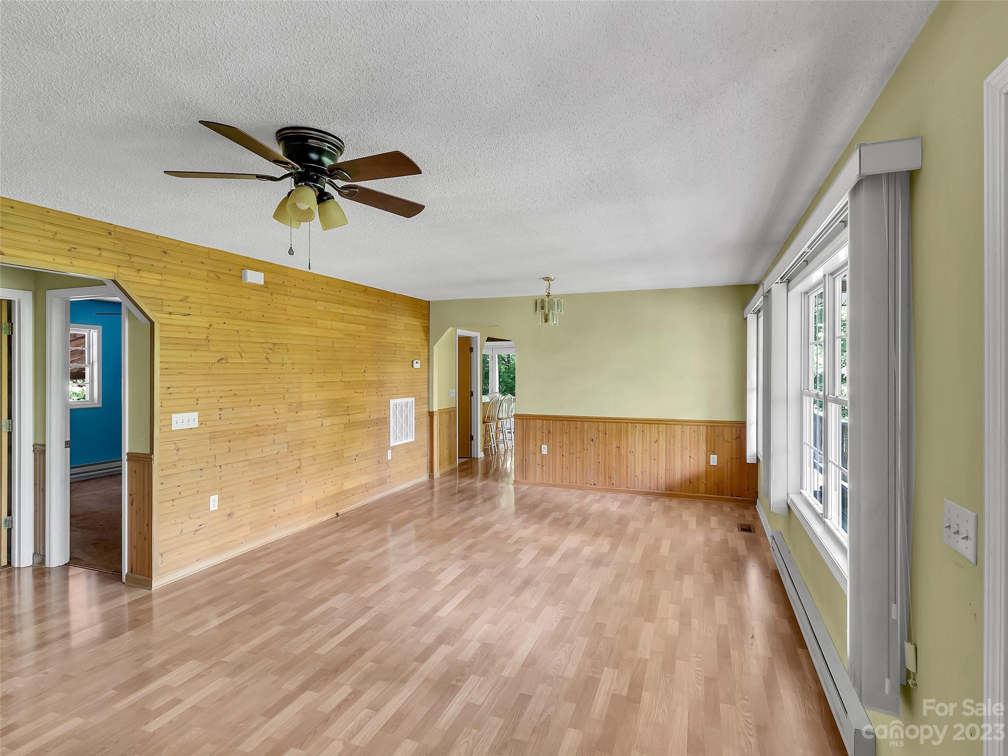 799 Nellie John Drive Clyde, NC 28721 - Photo 20 of 38 a view of empty room with wooden floor and fan
