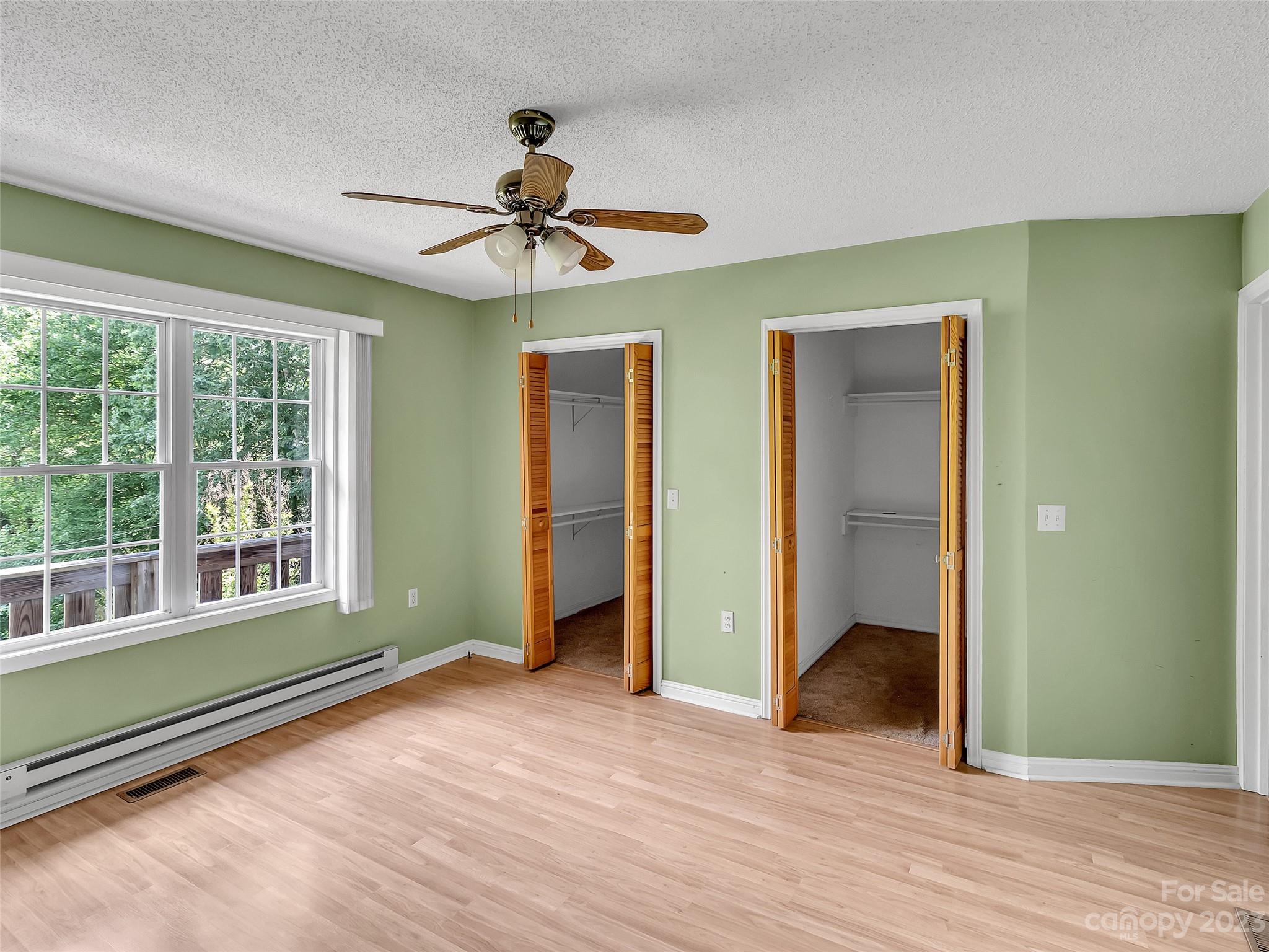 799 Nellie John Drive Clyde, NC 28721 - Photo 27 of 38 a view of empty room with wooden floor and fan