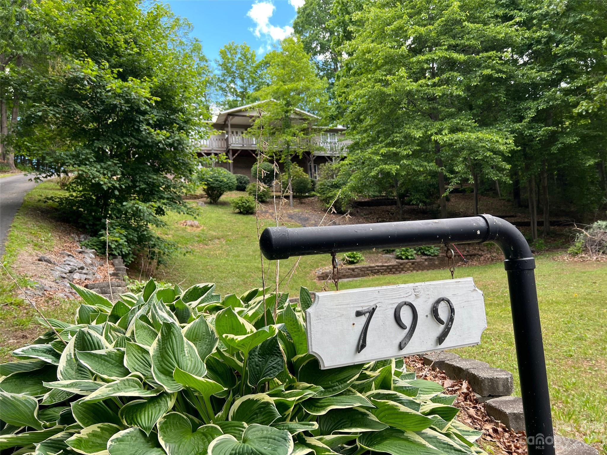 799 Nellie John Drive Clyde, NC 28721 - Photo 34 of 38 a sign that is sitting on a brick wall