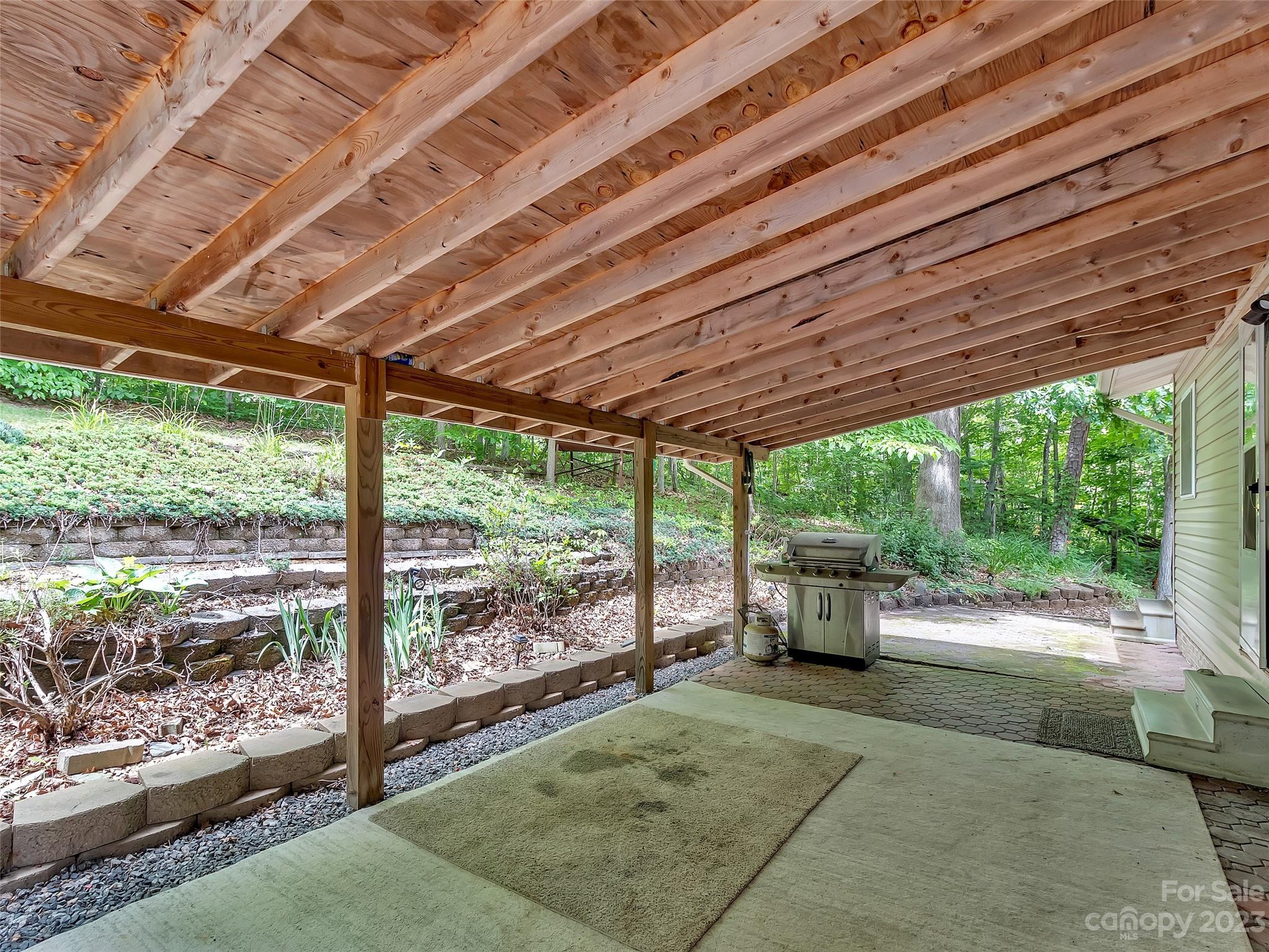 799 Nellie John Drive Clyde, NC 28721 - Photo 9 of 38 a backyard of a house with a garden and outdoor seating