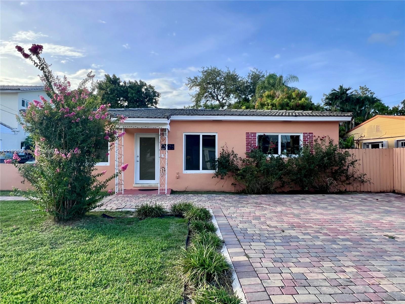6225 Southwest 26th Street Miami, FL 33175 - Photo 1 of 10 a front view of a house with a yard and potted plants