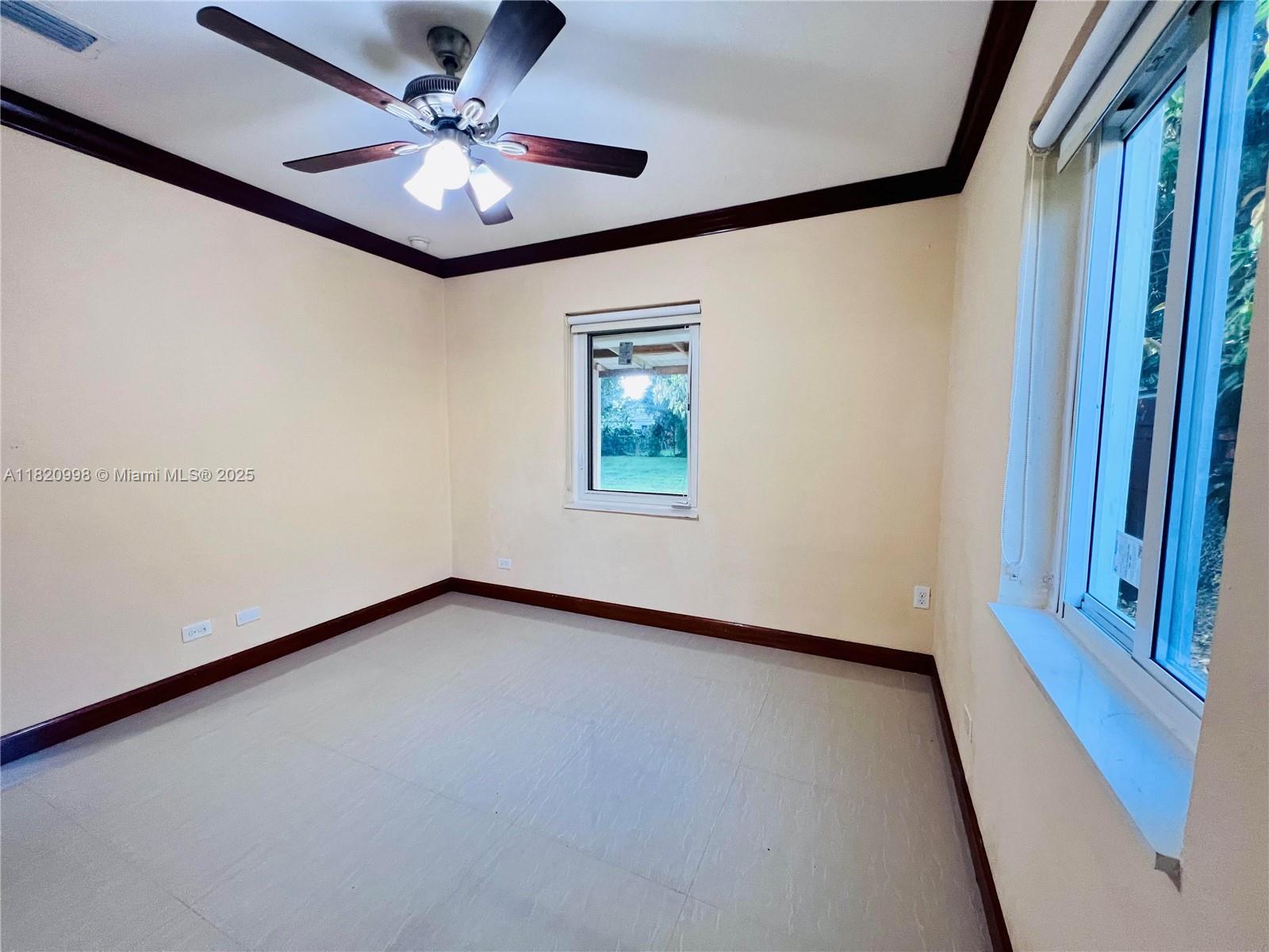 6225 Southwest 26th Street Miami, FL 33175 - Photo 8 of 10 wooden floor in an empty room with a window