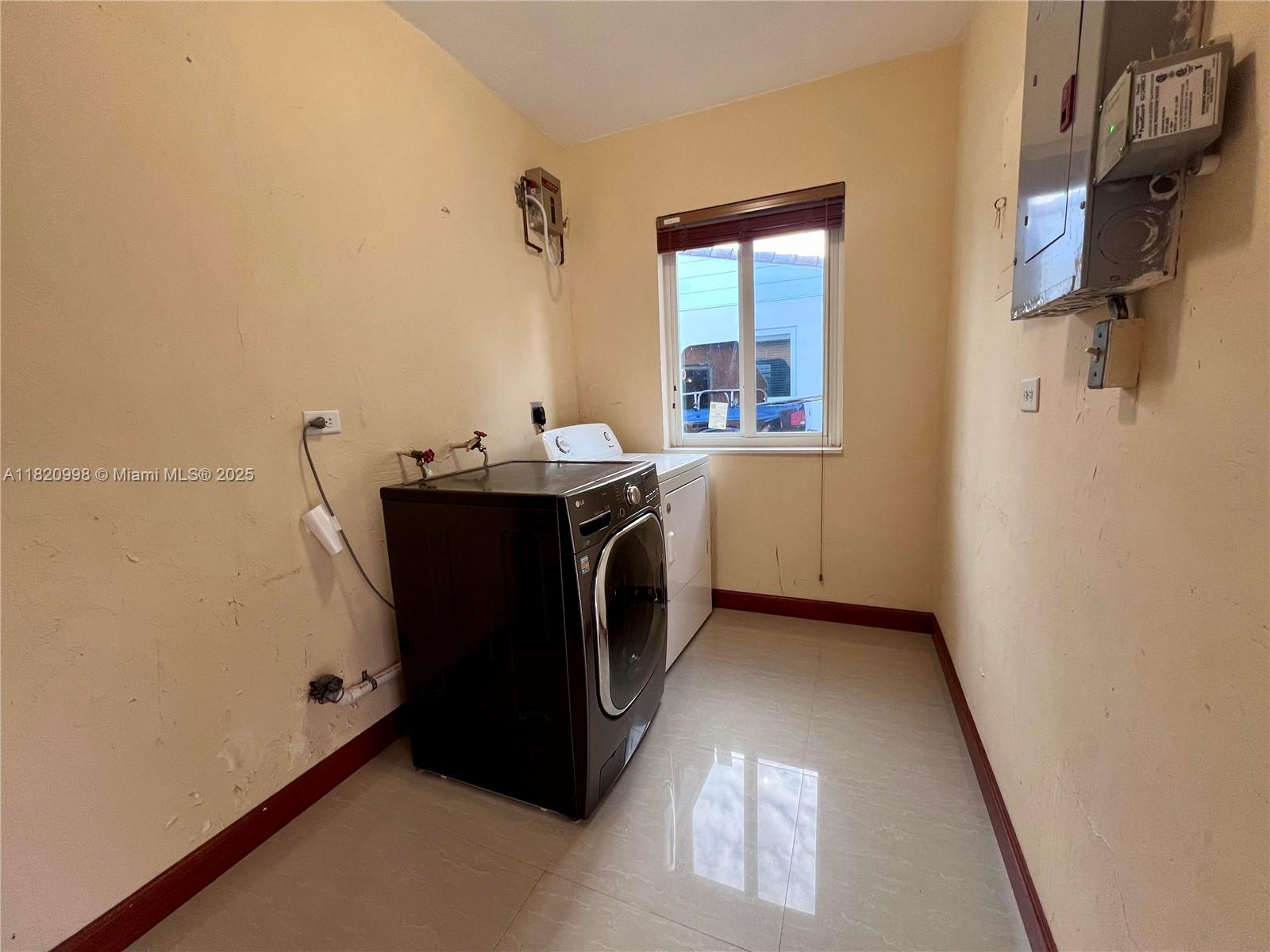 6225 Southwest 26th Street Miami, FL 33175 - Photo 9 of 10 a utility room with cabinets washer and dryer