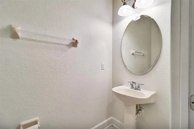 a bathroom with a sink and mirror