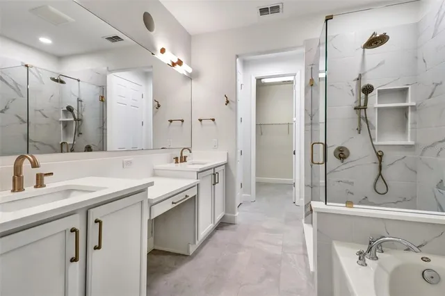a bathroom with a double vanity sink mirror double and shower
