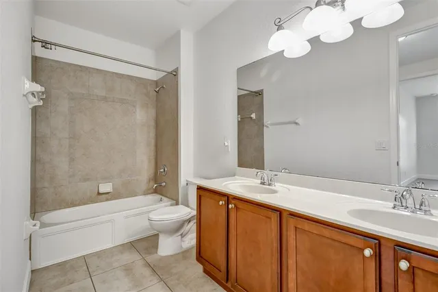 a bathroom with a double vanity sink mirror and toilet
