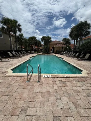 a view of a backyard with swimming pool