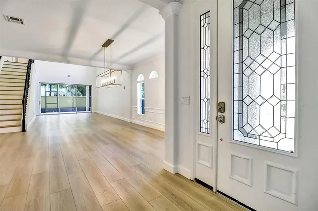 a view of a room with wooden floor and windows