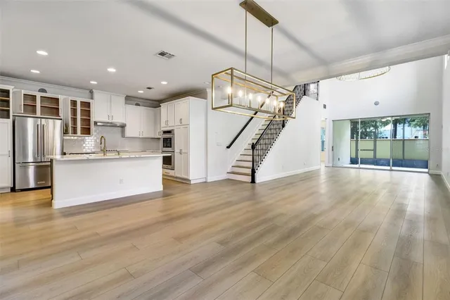 a view of kitchen with cabinets and wooden floor