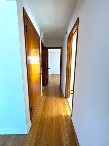 wooden floor in a room next to a window