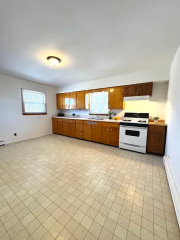 a kitchen with stainless steel appliances a stove and more cabinets