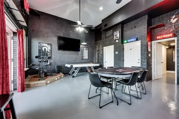 a roof deck with couches and wooden floor