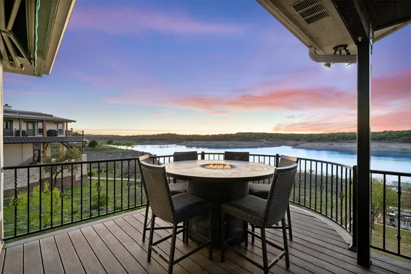 a kitchen with sink a refrigerator and chairs