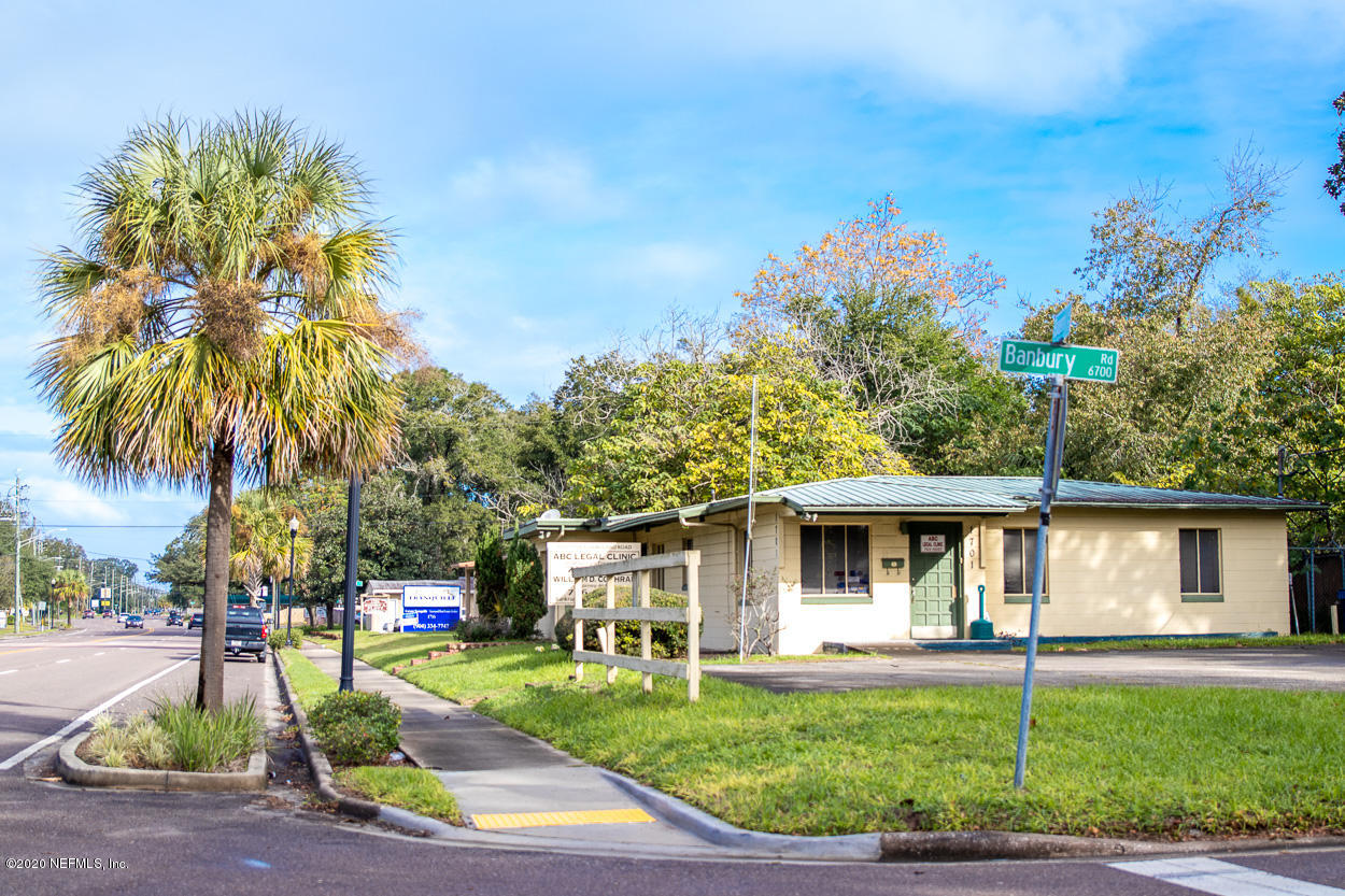 1701 Rogero Road Jacksonville, FL 32211 - Photo 1 of 20 a front view of a house with a yard and garage