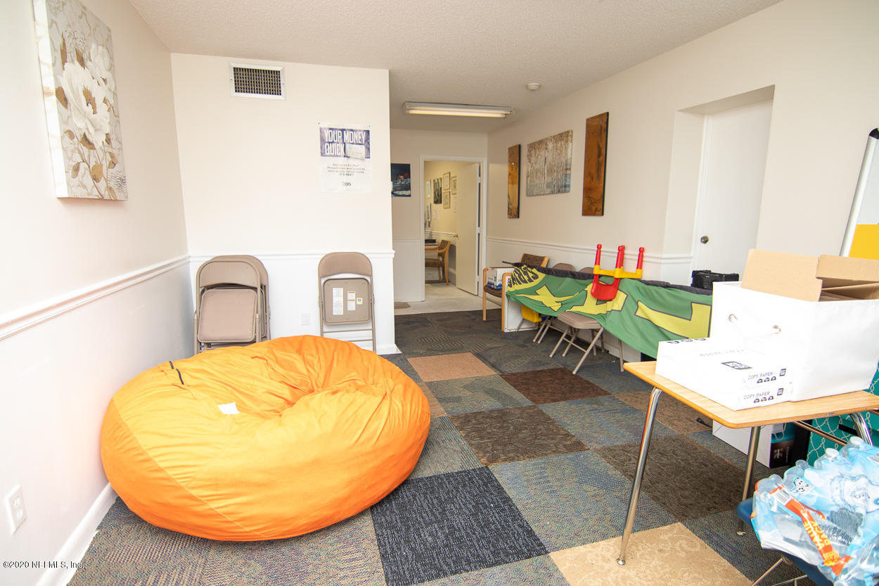 1701 Rogero Road Jacksonville, FL 32211 - Photo 11 of 20 a living room with furniture and a chair
