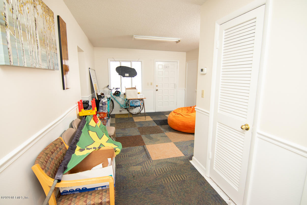 1701 Rogero Road Jacksonville, FL 32211 - Photo 12 of 20 a bedroom with furniture and a window