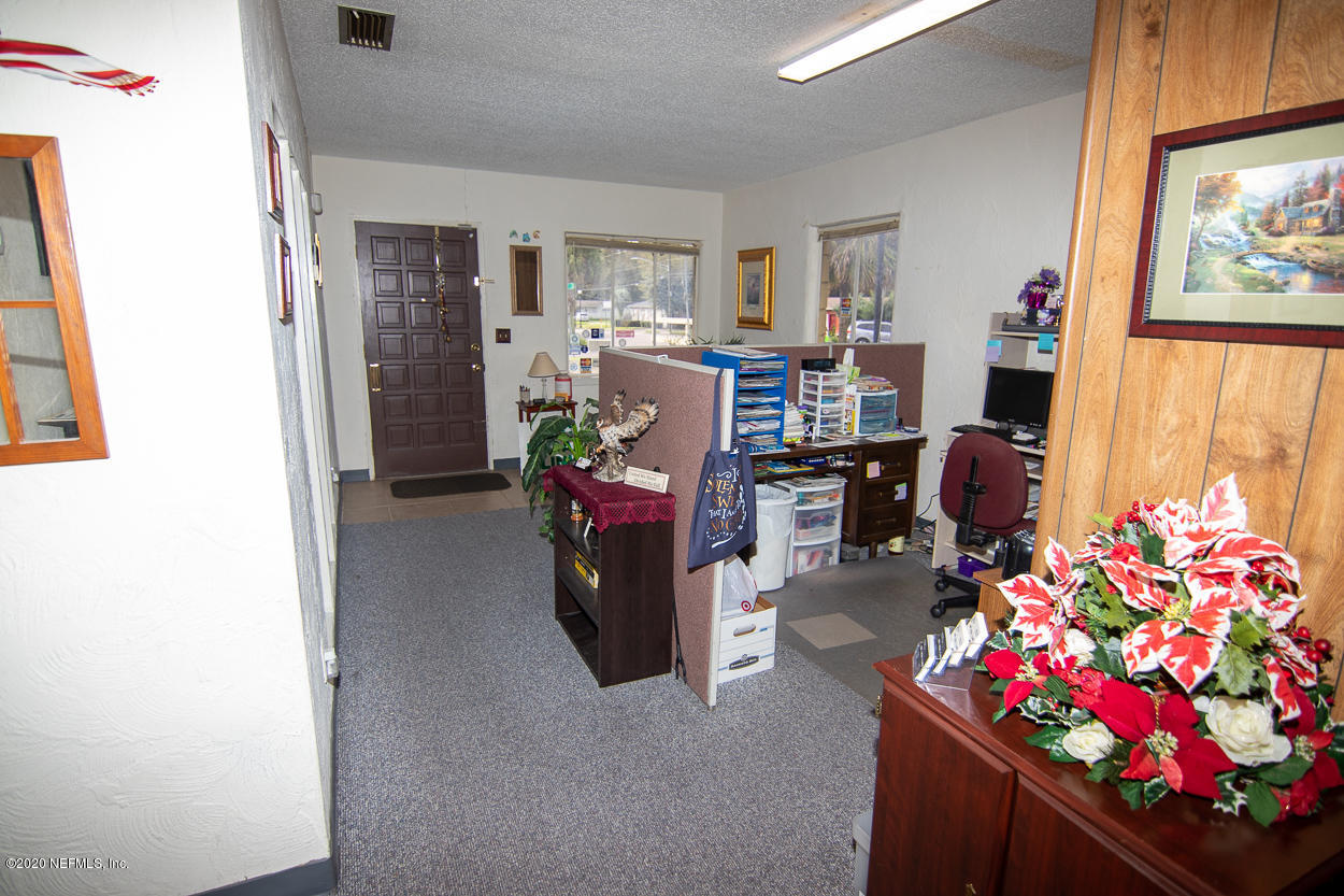 1701 Rogero Road Jacksonville, FL 32211 - Photo 16 of 20 a workspace with furniture and a fireplace