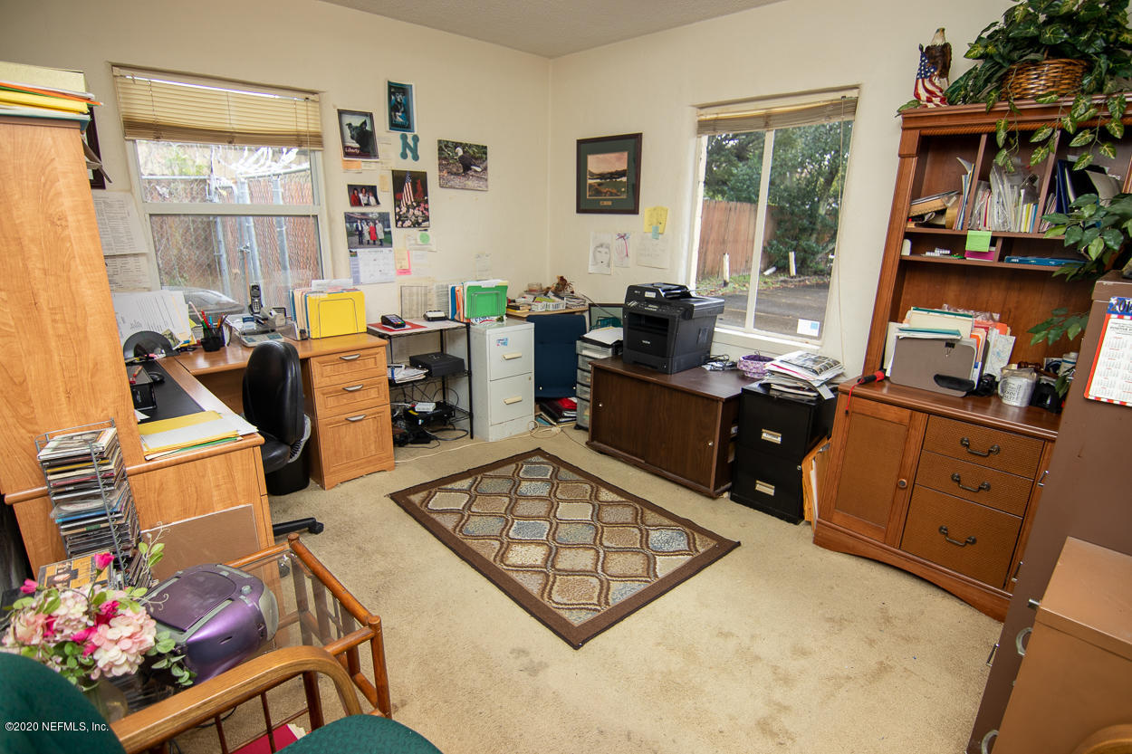 1701 Rogero Road Jacksonville, FL 32211 - Photo 17 of 20 a view of a workspace with furniture and a window