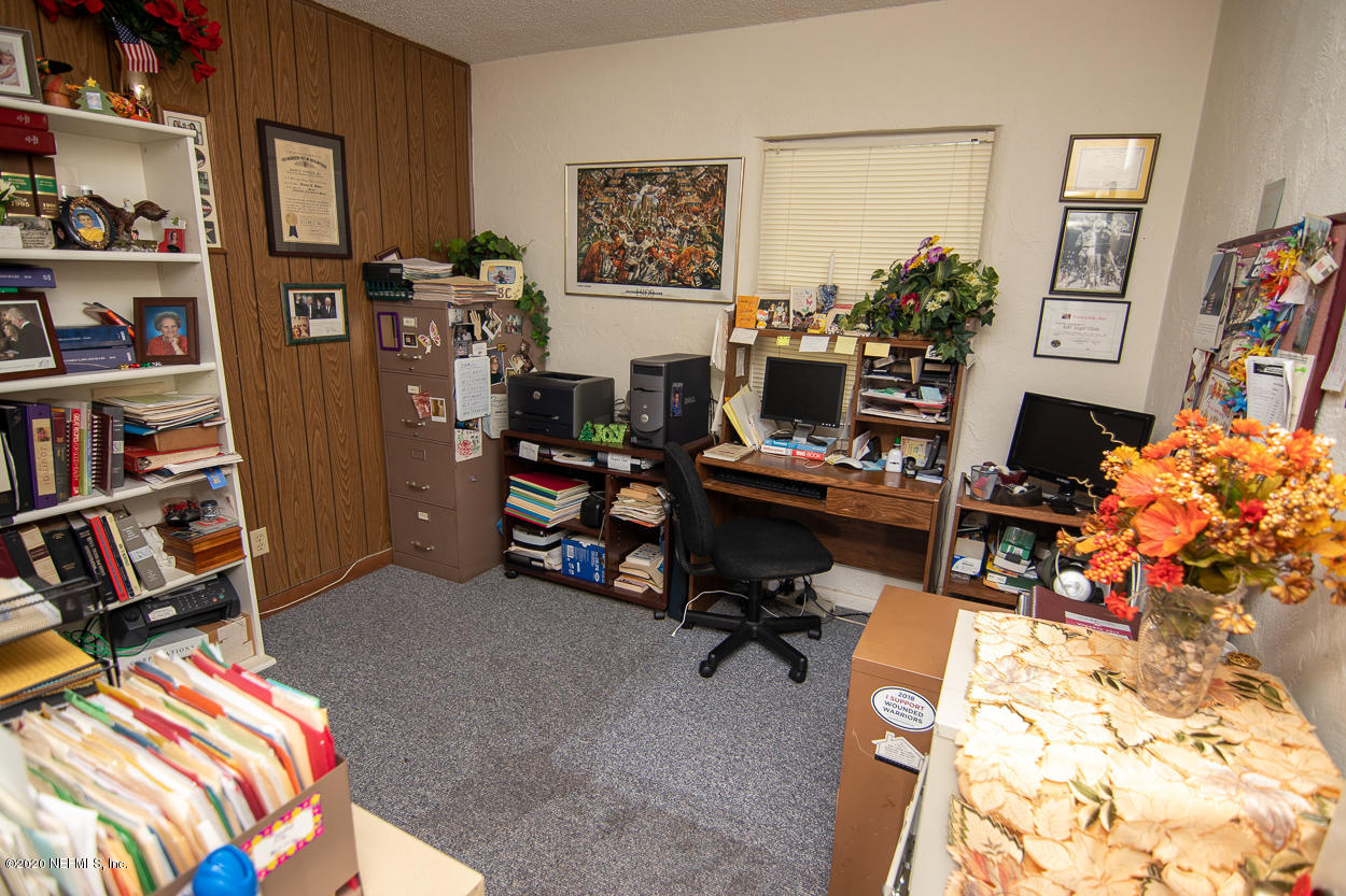 1701 Rogero Road Jacksonville, FL 32211 - Photo 18 of 20 a workspace with furniture and a book shelf
