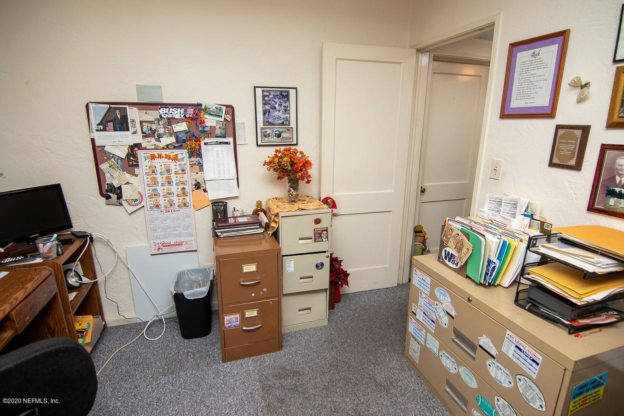 1701 Rogero Road Jacksonville, FL 32211 - Photo 19 of 20 a bedroom with a bed and a desk