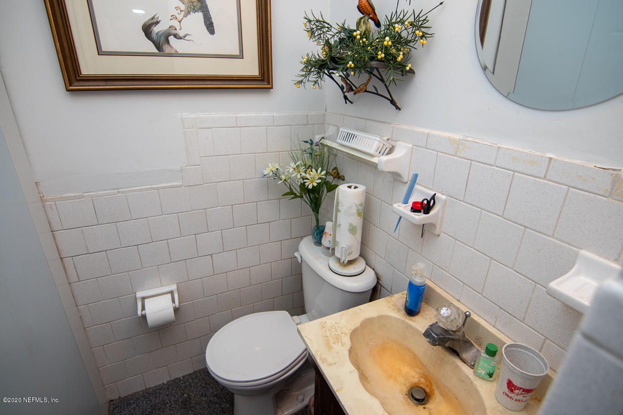 1701 Rogero Road Jacksonville, FL 32211 - Photo 20 of 20 a bathroom with a toilet sink and mirror