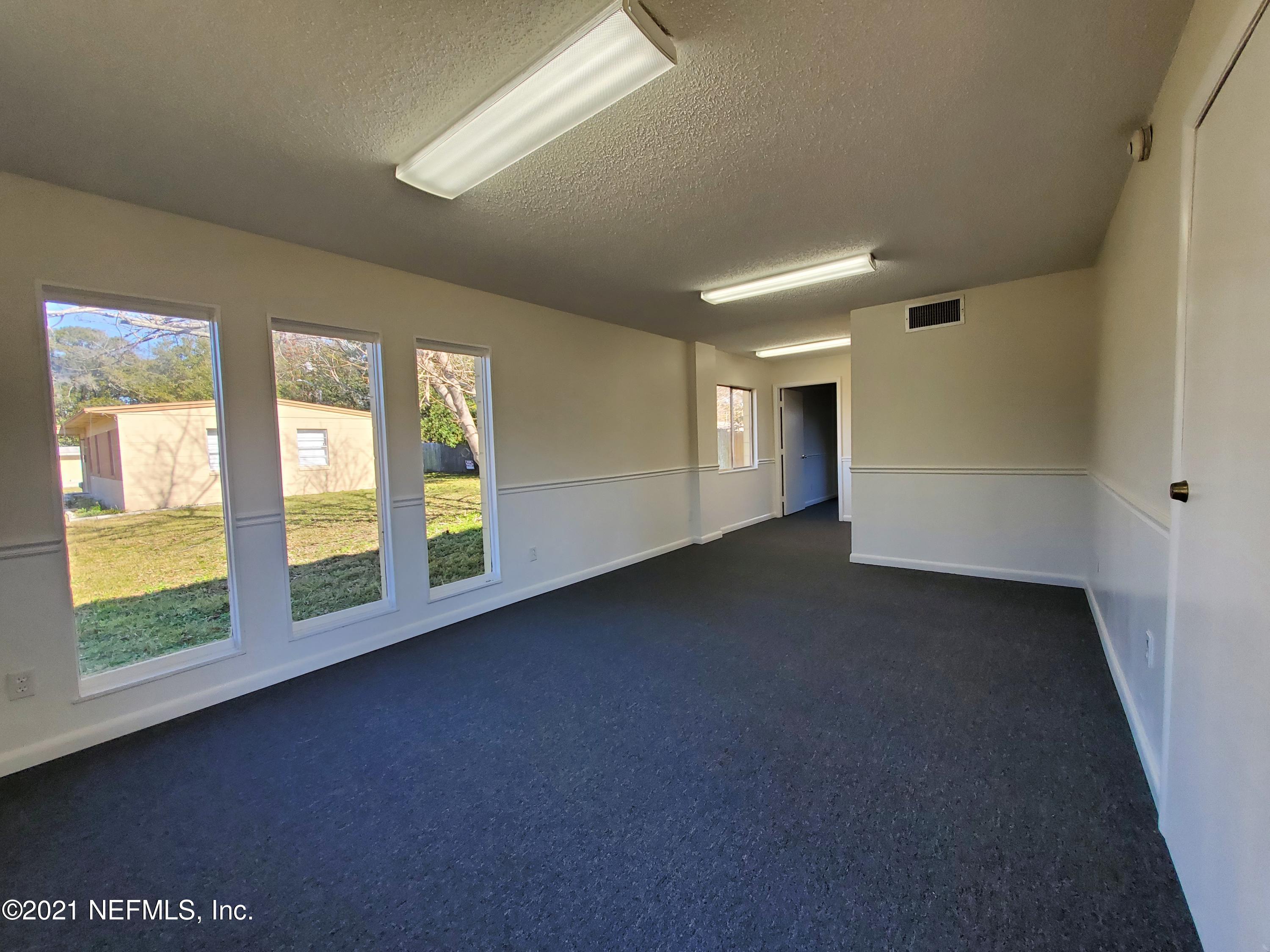 1701 Rogero Road Jacksonville, FL 32211 - Photo 7 of 20 a view of an empty room with a window