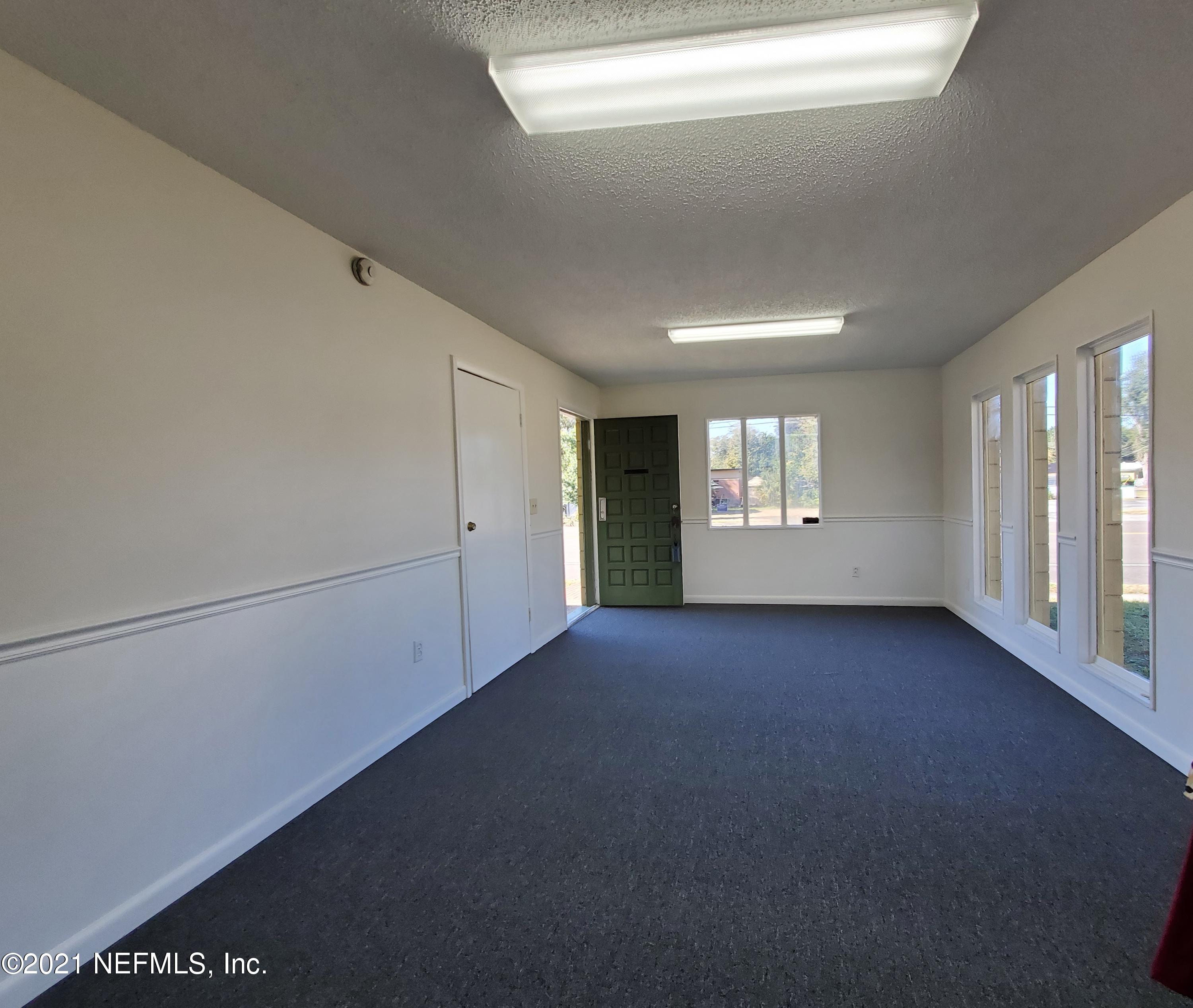 1701 Rogero Road Jacksonville, FL 32211 - Photo 8 of 20 a view of an empty room with a window and fireplace