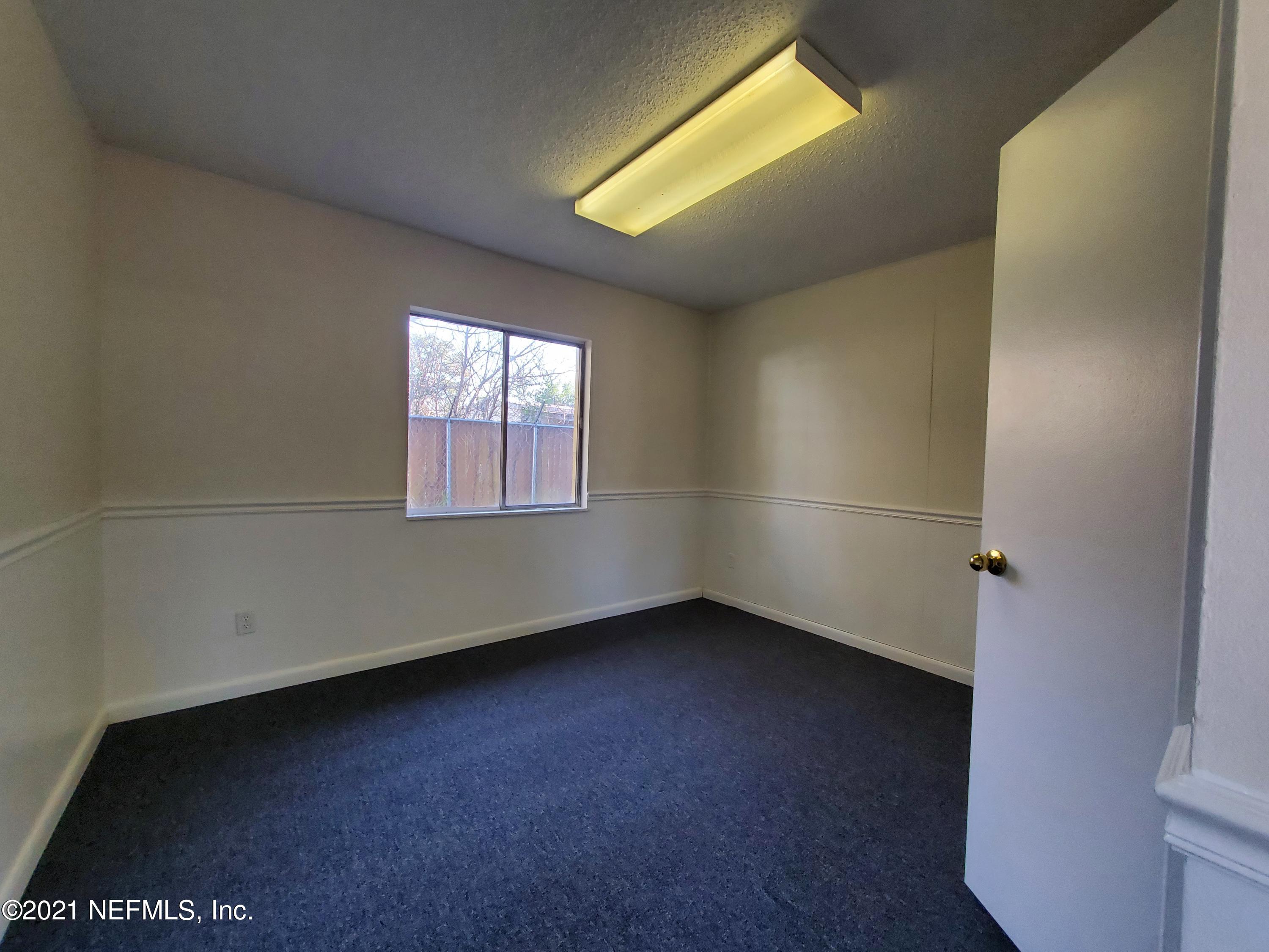 1701 Rogero Road Jacksonville, FL 32211 - Photo 9 of 20 an empty room with windows