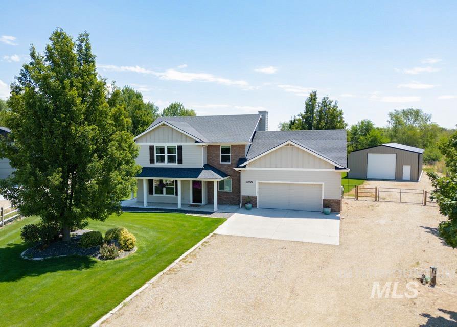 23800 Breyer Road Caldwell, ID 83607 - Photo 47 of 50 Two-story residence featuring a gray shingle roof, light-colored siding, and brick accents