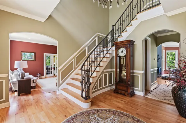 a view of entryway and hall with wooden floor