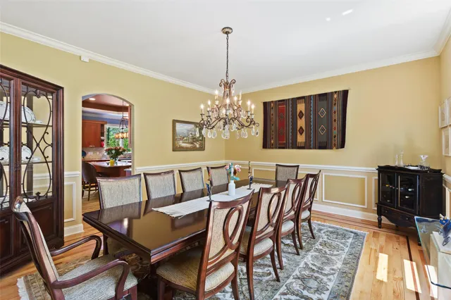 a view of a dining room with furniture and chandelier