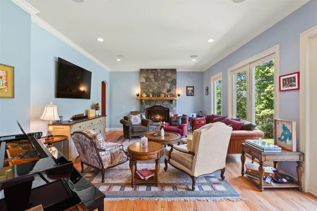 a living room with fireplace furniture and a flat screen tv