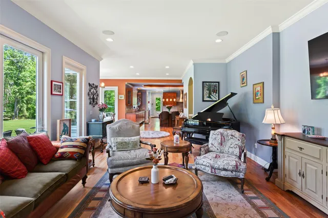 a living room with furniture gym equipment and a large window