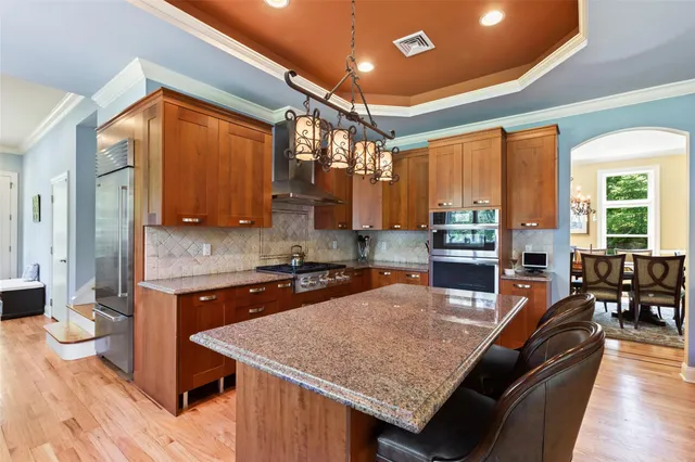 a kitchen with granite countertop lots of counter top space and stainless steel appliances