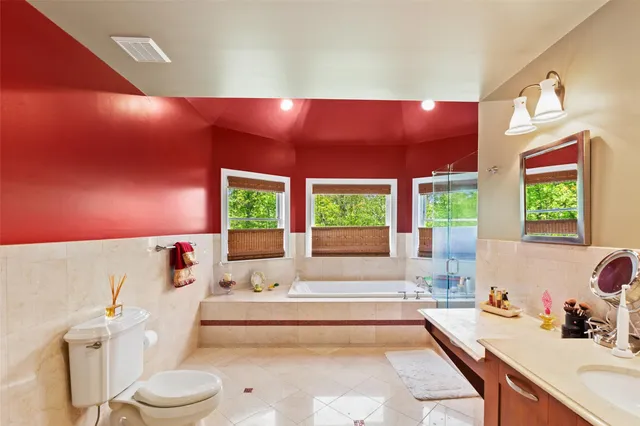 a spacious bathroom with a large tub and sink