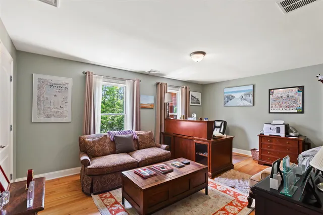 a living room with furniture a rug and a window