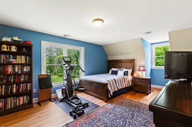 a bedroom with bed and a bookshelf
