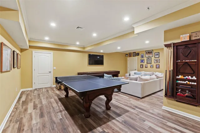 a room with furniture pool table and flat screen tv