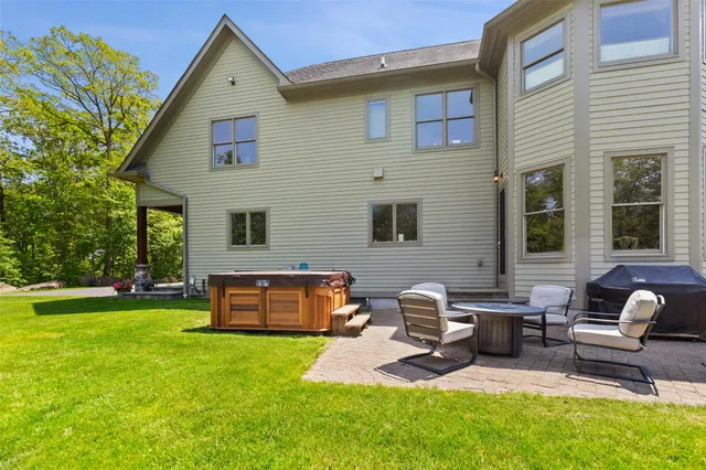 a front view of a house with garden and sitting area
