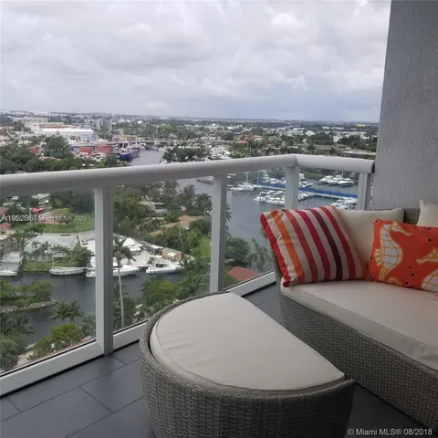 a bedroom with a bed and a refrigerator