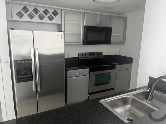 a bathroom with a granite countertop toilet a sink and a mirror