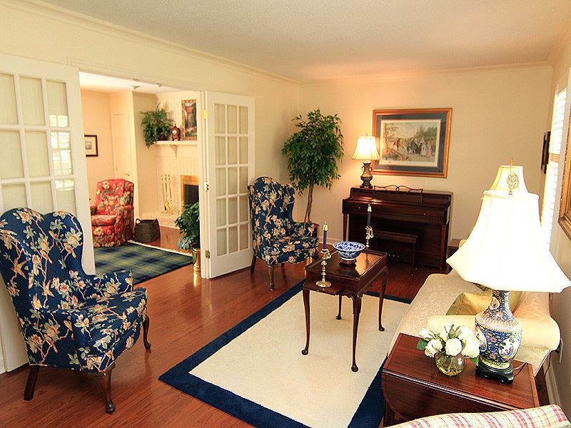 113 Dabney Road Cary, NC 27511 - Photo 3 of 19 Main level Hardwoods and plantation shutters on main level front windows add character to this home. Double glass doors opening to Family Room allow natural light to filter through these living areas. Living Room