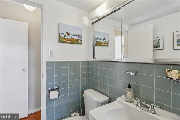 a kitchen with white cabinets and window