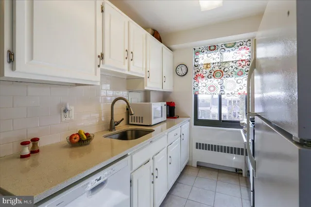 a kitchen with stainless steel appliances granite countertop a refrigerator and a stove