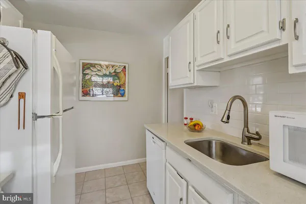 a bedroom with a bed and a view of kitchen