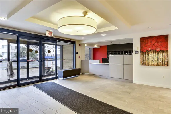 a living room with furniture a flat screen tv and a floor to ceiling window