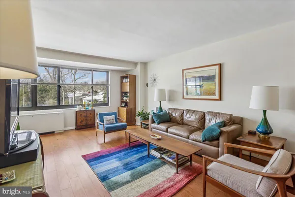 a dining room with furniture window and wooden floor