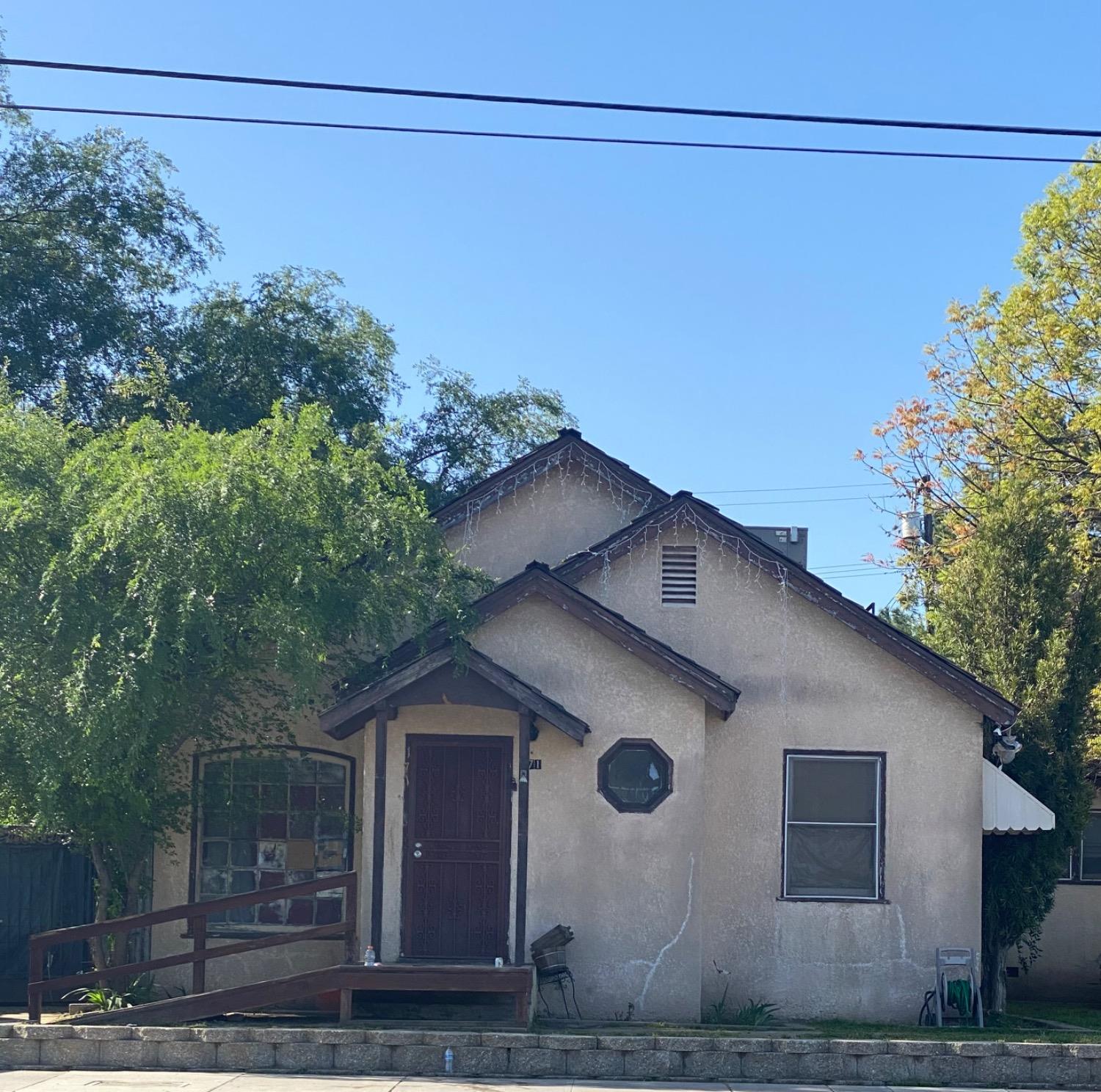 171 Manning Avenue Reedley, CA 93654 - Photo 1 of 1 a front view of a house with garden